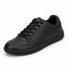 Zapatilla minimalista negra de piel sintética, estilo urbano y oficina.